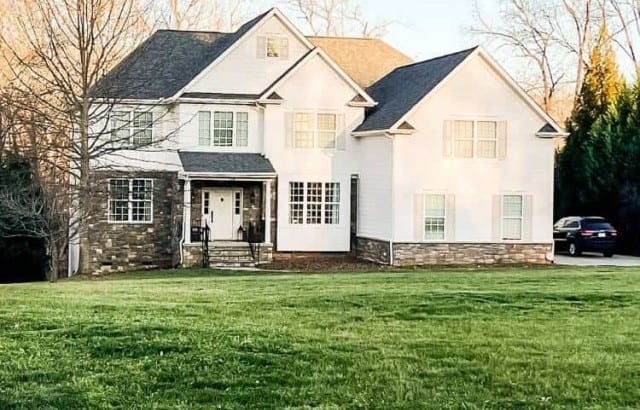 pulled back view of house from street before new landscape installation