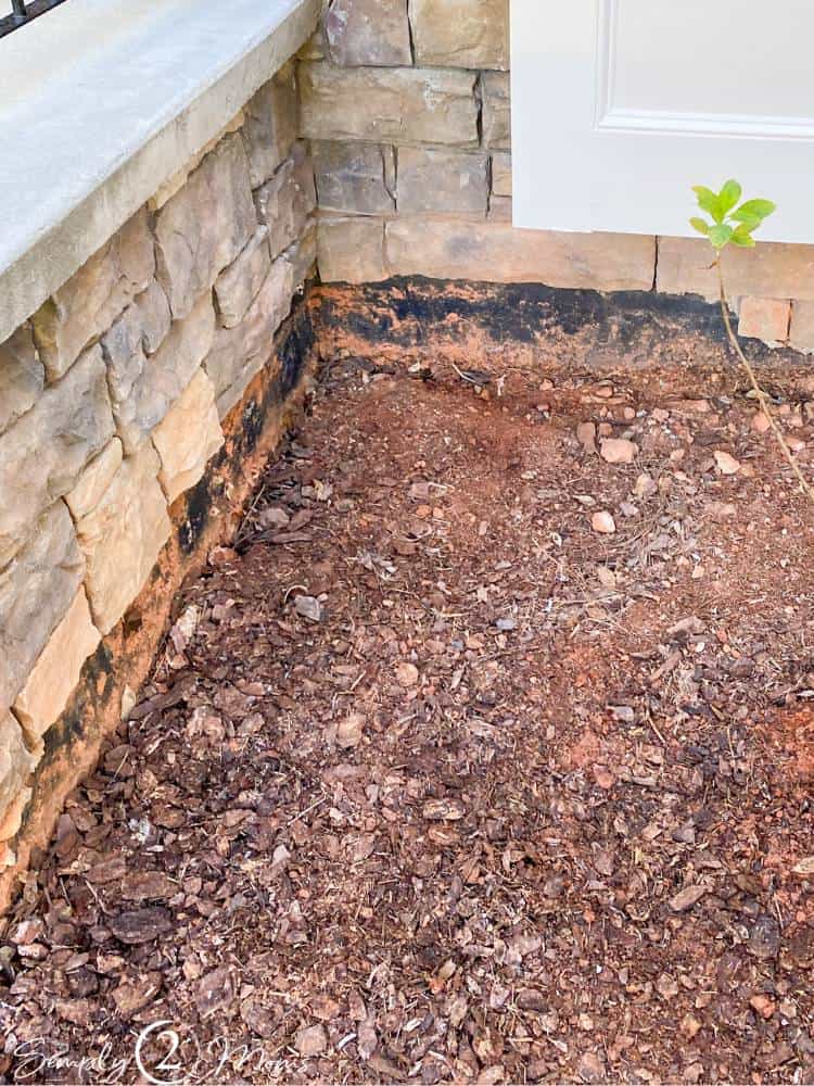 view of ground sinking next to foundation of home