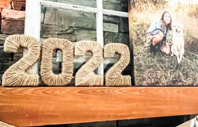 jute twine graduation year numbers on fireplace mantle with other party decor for graduation