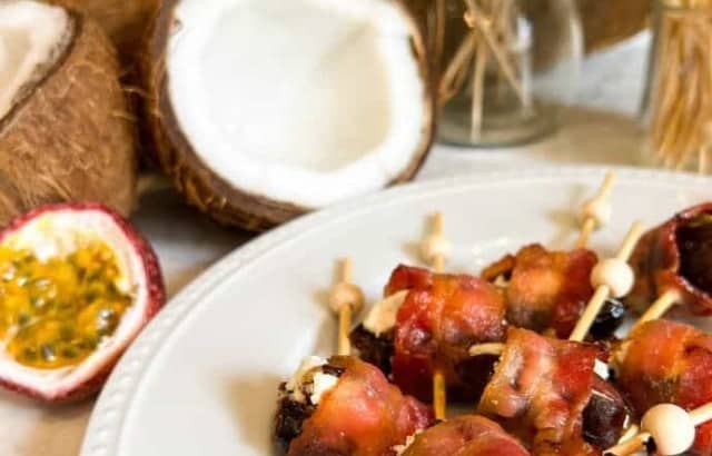 Plate with bacon-wrapped dates stuffed with goat cheese and almonds.