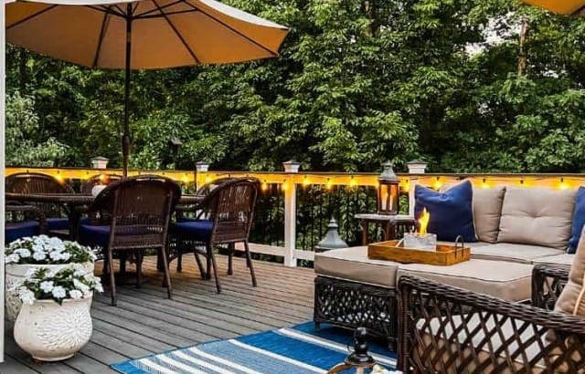 deck with string lights hung from railing