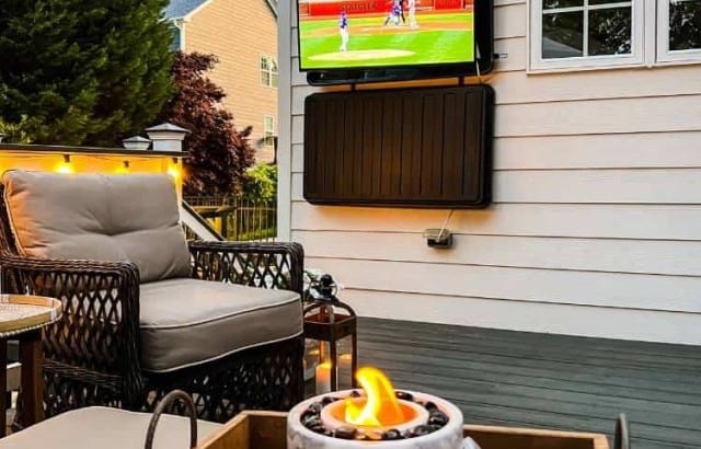 outdoor tv hung on back of house