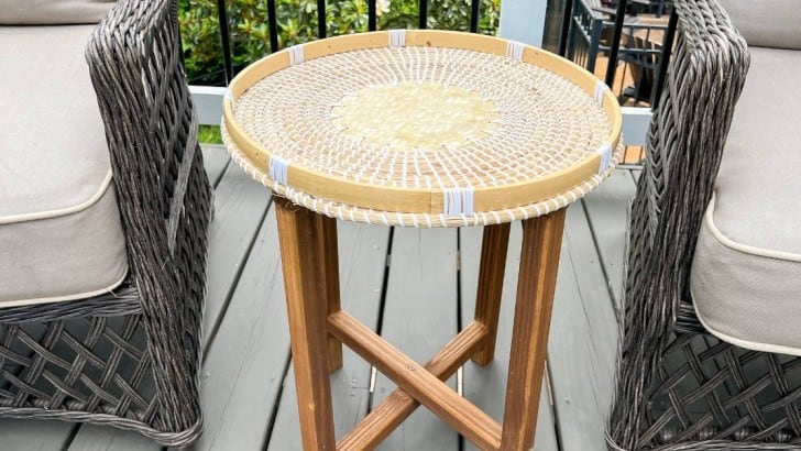 wood and basket topped table in between two outdoor chairs on deck feature photo