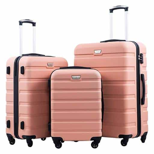 set of three pink suitcases