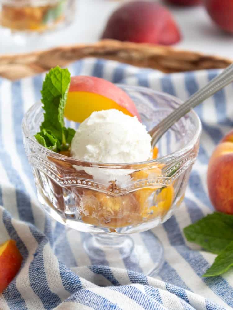 Footed dessert glass with peach dump cake from Midwest Life and Style.