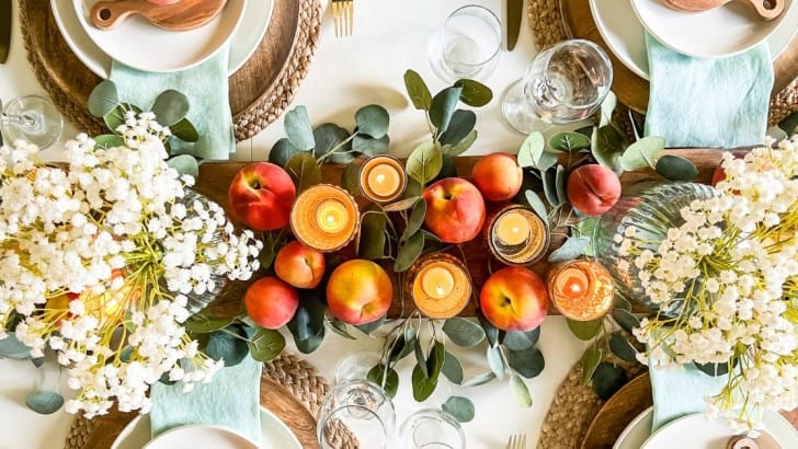 overhead view of table decorating with fresh peaches and faux flowers