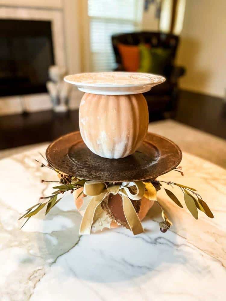 pumpkins and plates stacked to create a tiered tray look