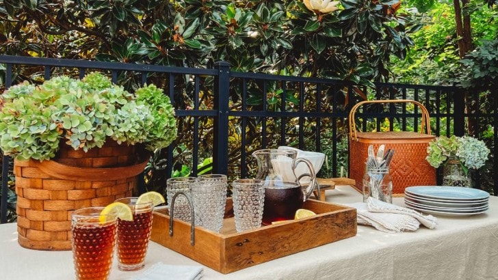 outdoor table set with flowers and dinnerware essentials for buffet