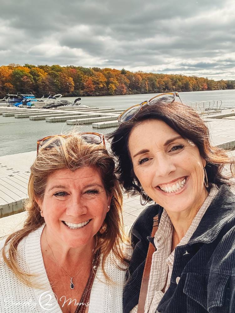 blogger and her friend taking a selfie with lake behind them