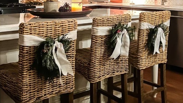 three counter bar stools with wreaths tied to the backs with wide ribbon feature photo