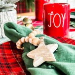 red and green table setting with mug and star napkin ring feature