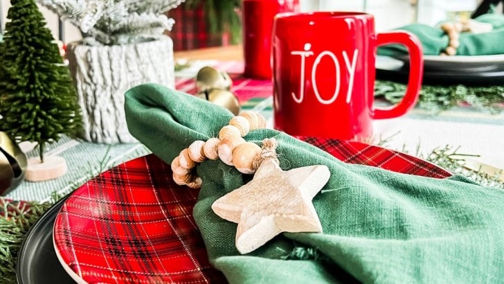 red and green table setting with mug and star napkin ring feature