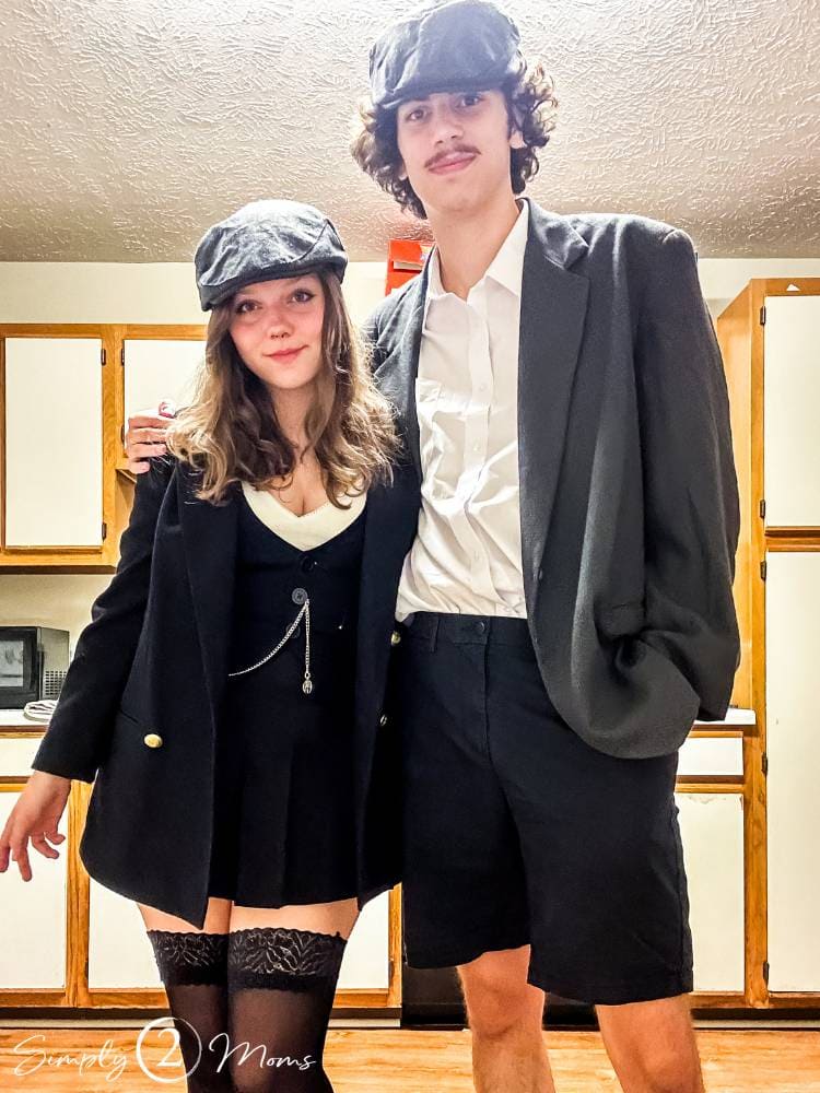 college students standing in kitchen dressed as Peaky Blinders for Halloween