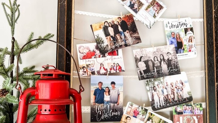 close up of DIY frame and ribbon greeting card holder with faux tree and lantern beside it