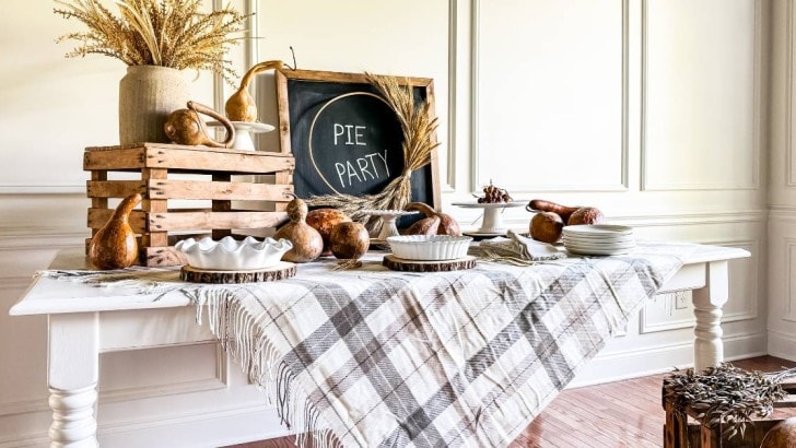 buffet table set with neutral rustic wood, gourds and wheat accents for pie party feature photo