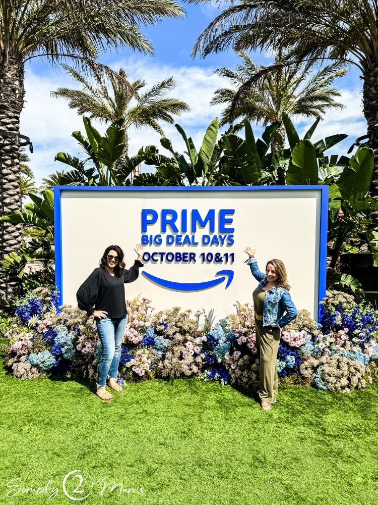 Simply2Moms bloggers standing in front of Amazon Prime Big Deal Days sign.