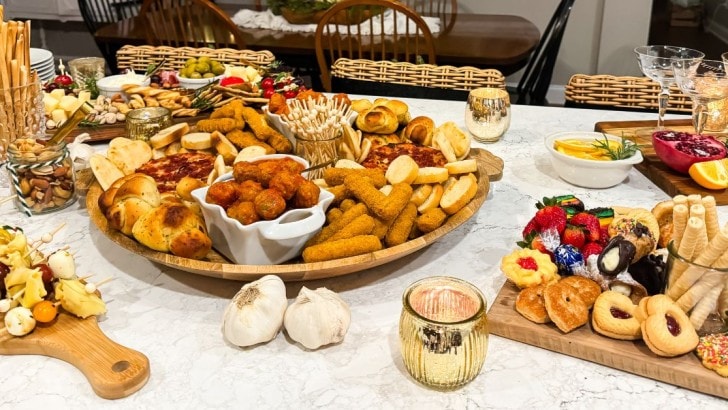 Several themed charcuterie boards on a kitchen island.