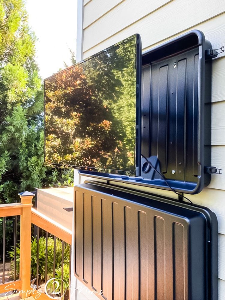 TV pulled out on mount within outdoor TV cover shell