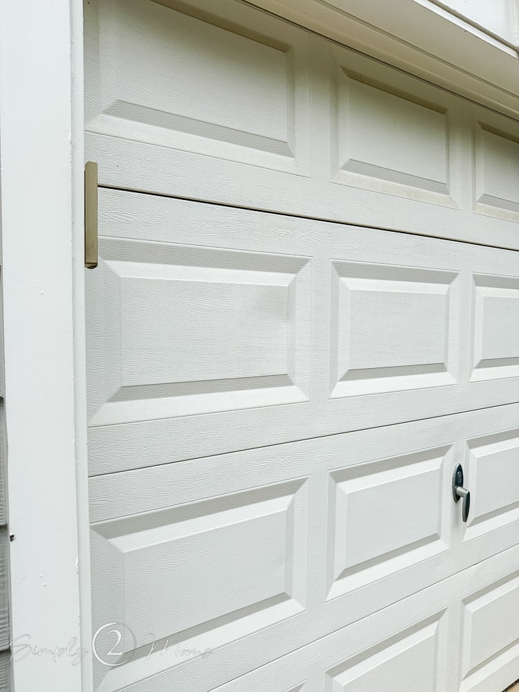 Dented raised panel steel garage doors with galvanized steel handle and lock.