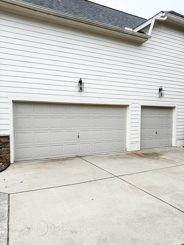 Builder basic garage doors painted Anew Gray on a side load garage.