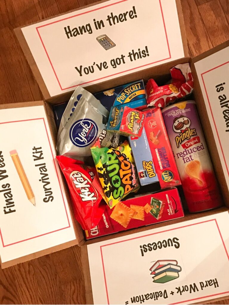 Finals survival care package for college students with snacks, popcorn, candy, and motivational messages printed inside the box panels