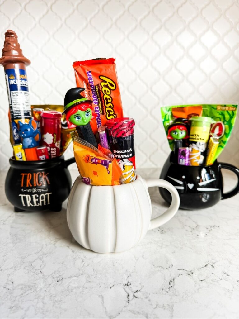 Halloween college care package idea using pumpkin mugs filled with candy and small treats arranged as festive boo baskets