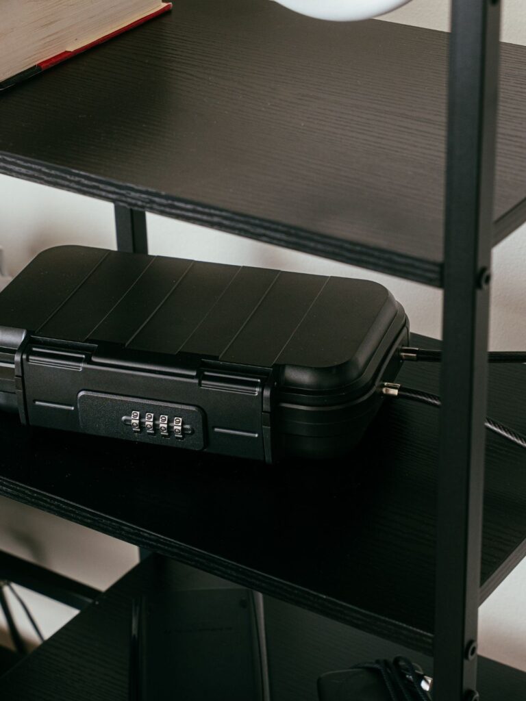 Black lock box with combination lock on desk shelf