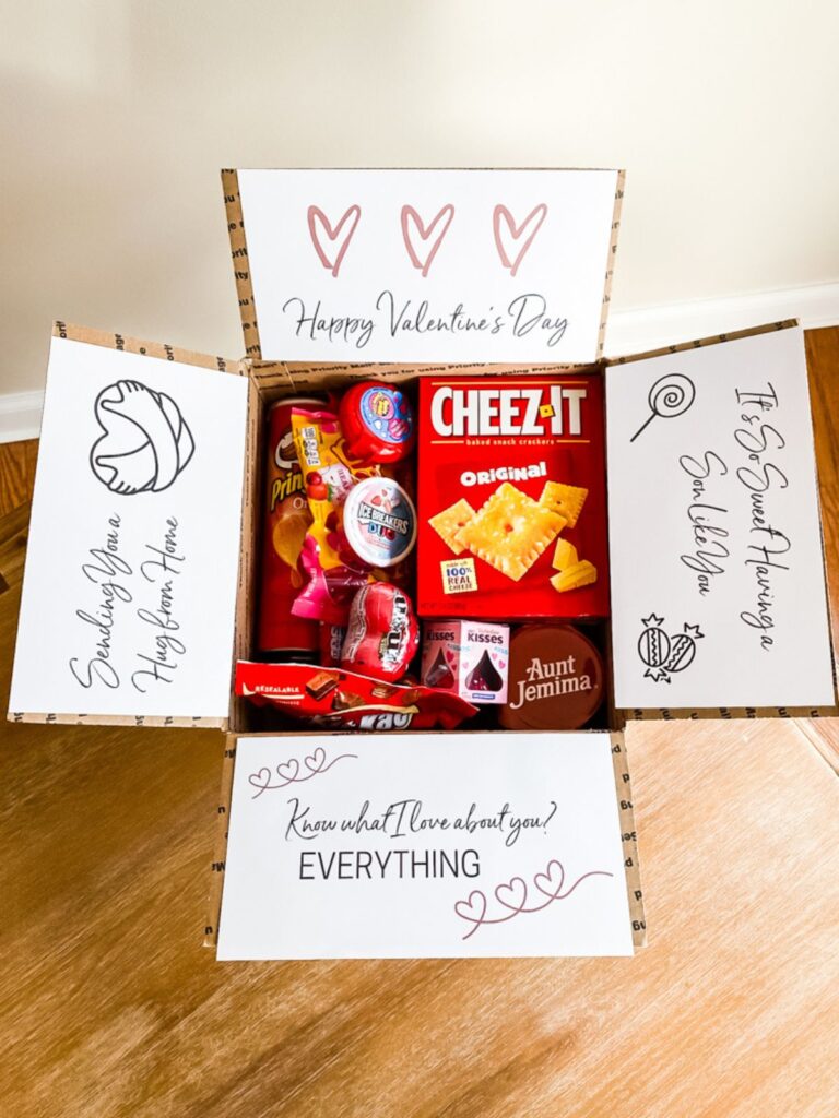 Open Valentine’s Day college care package filled with snacks and candy, featuring printed messages inside the box panels