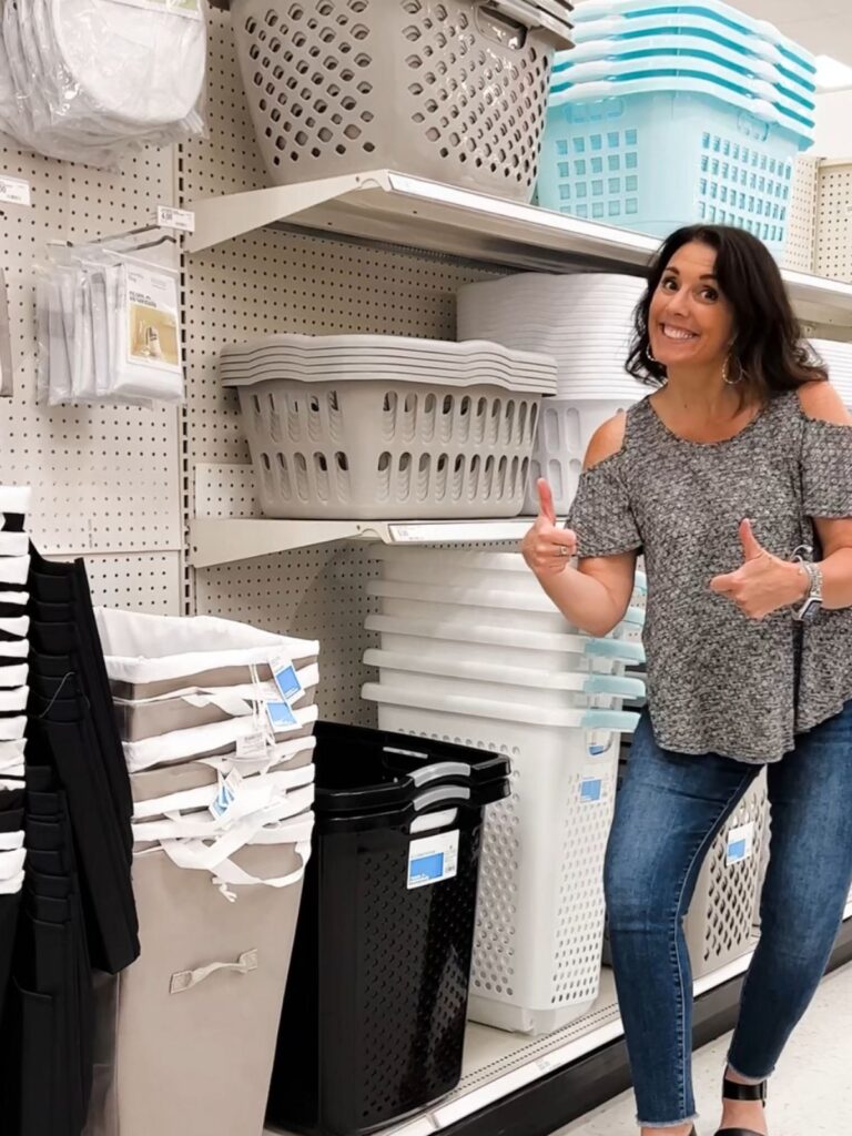 Woman shopping for storage bins and organizers in store aisle